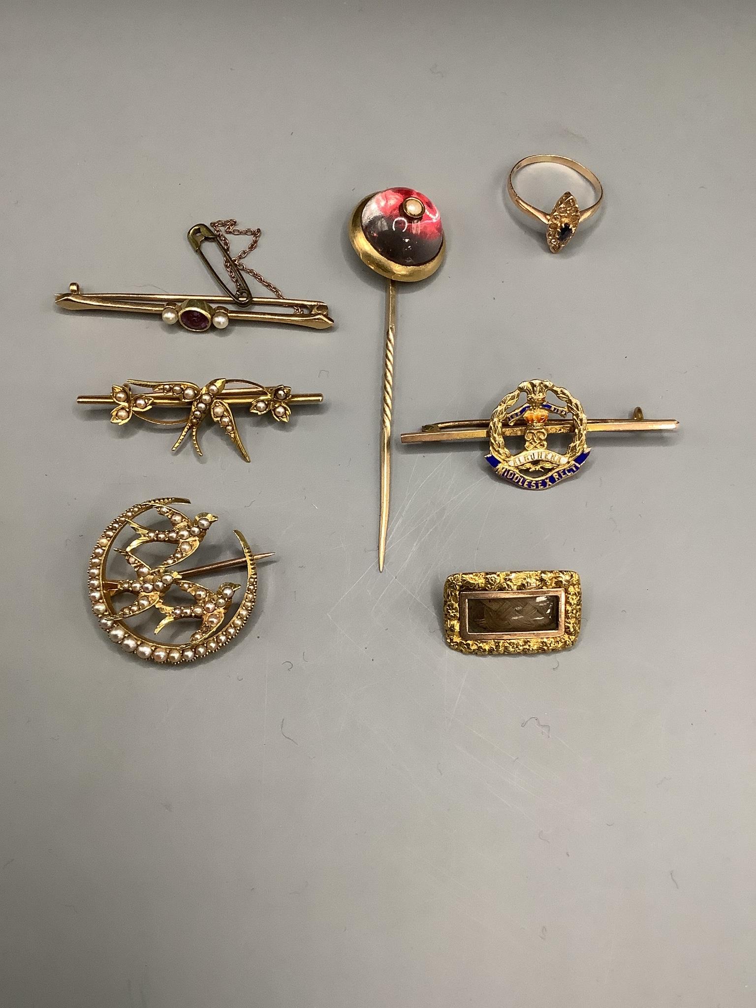 Mixed mainly Victorian jewellery including two yellow metal and seed pearl set swallow brooches, a 9ct and enamel military brooch, a 15ct and gem set bar brooch, a foil backed rock crystal and split pearl set stick pin,